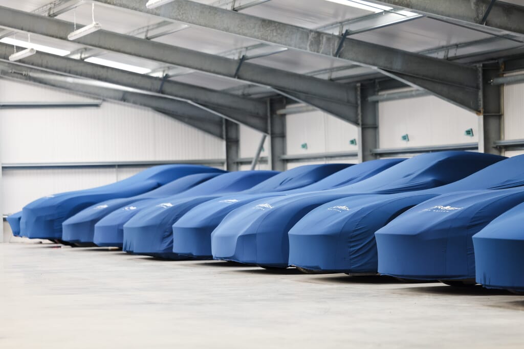 Cars under protective cloths in storage