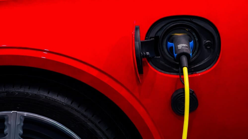 Close-up,Of,A,Red,Electric,Car,Charging,,Highlighting,The,Port,